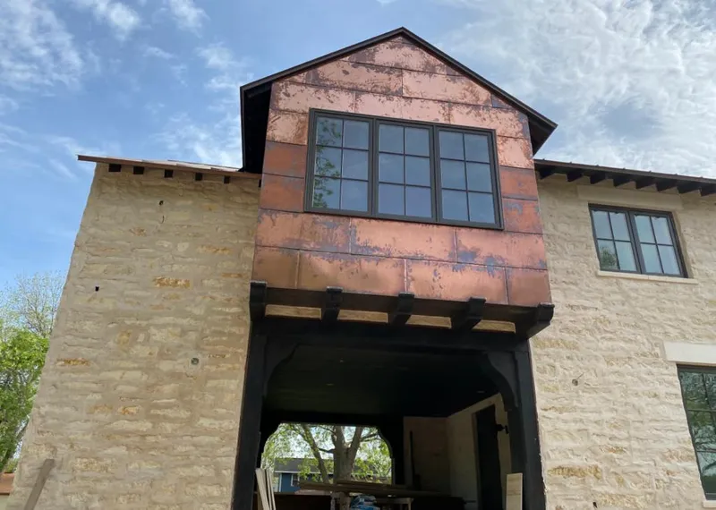Copper metal panel facade on a stone building for Skylight Installation in Rehoboth